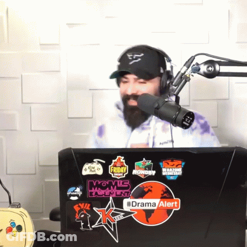 Man In Hat And Headphones In Front Of Microphone With Drama Alert Sticker GIF