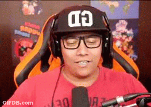 Man In Hat And Headphones Sitting At Microphone GIF