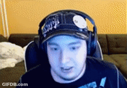 Man In Hat And Headphones Sitting In Chair GIF