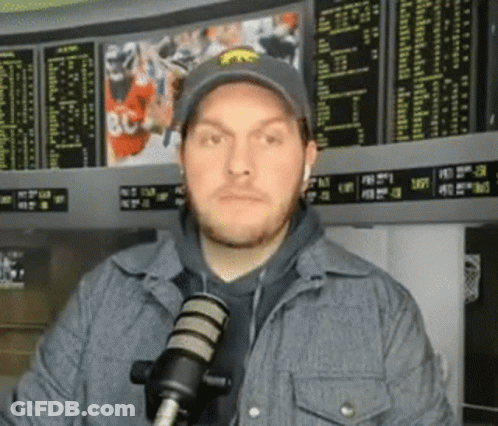Man In Hat And Jacket At Microphone GIF