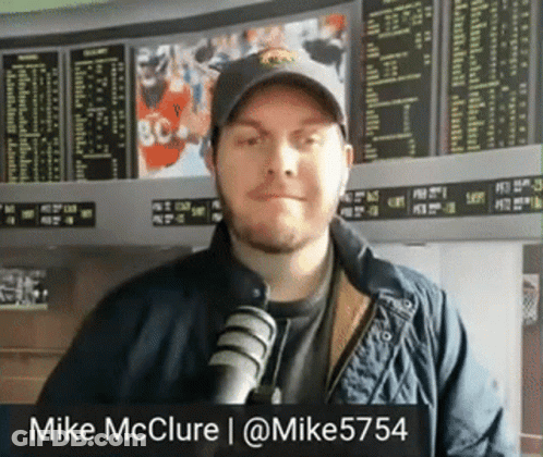 Man In Hat And Jacket At Microphone Mike McClure GIF