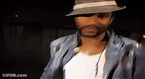 Man In Hat And Jacket Looking At Camera GIF