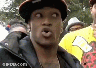 Man In Hat And Jacket Making Funny Face In Crowd GIF