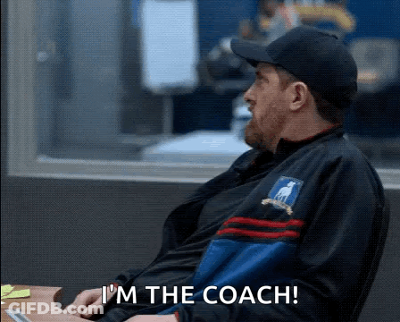 Man In Hat And Jacket Sitting At Desk GIF
