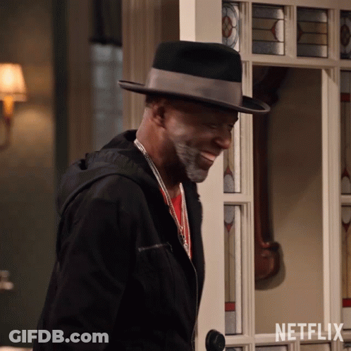 Man In Hat And Jacket Standing Before Netflix Door GIF