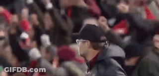 Man In Hat And Jacket Walking In Front Of Crowd GIF