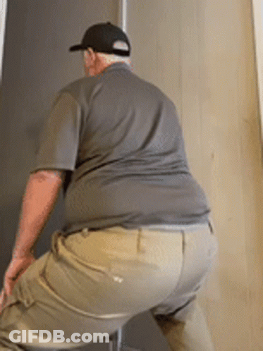 Man In Hat And Khaki Pants Squatting GIF