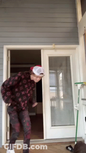 Man In Hat And Louis Vuitton Jacket Standing Before Door GIF