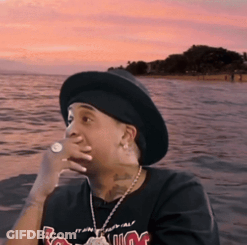 Man In Hat And M T-Shirt Sitting By Water GIF
