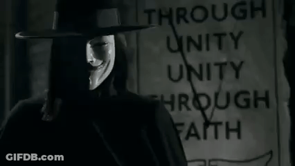 Man In Hat And Mask Standing In Front Of Through Unity Through Faith Sign GIF
