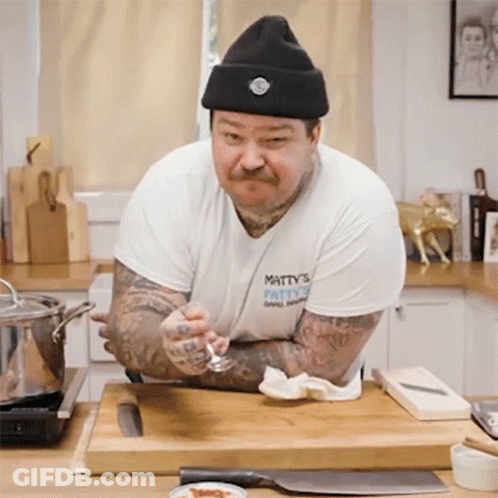 Man In Hat And Matty's Patty's Shirt GIF