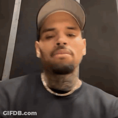 Man In Hat And Necklace Making Funny Face GIF