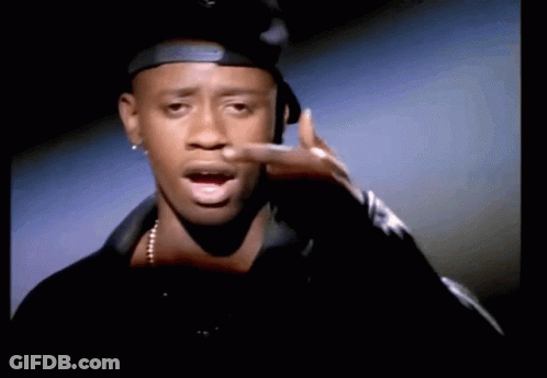 Man In Hat And Necklace Pointing GIF
