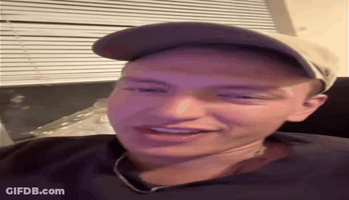 Man In Hat And Necklace Smiling GIF