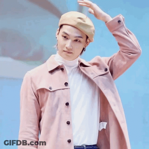 Man In Hat And Pink Jacket Holding Hand To Head GIF