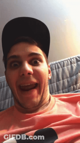 Man In Hat And Pink Shirt With Mickey Mouse Making Funny Face GIF