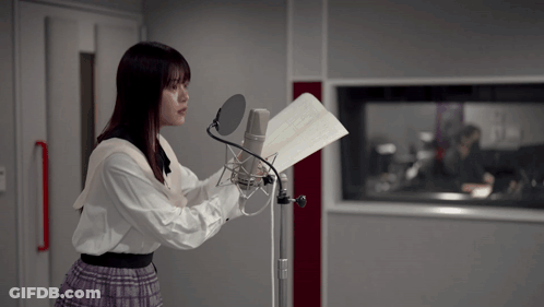 Man In Hat And Plaid Shirt At Microphone GIF