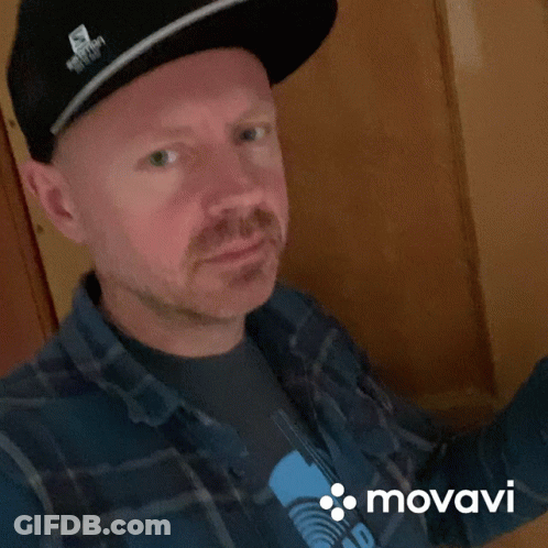 Man In Hat And Plaid Shirt With Movado GIF