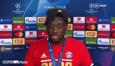 Man In Hat And Red Shirt In Front Of Lays And Nissan Ads GIF