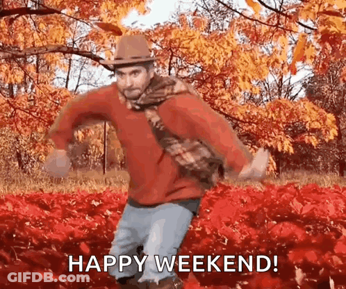 Man In Hat And Scarf Dancing In Leaves Says Happy Weekend GIF
