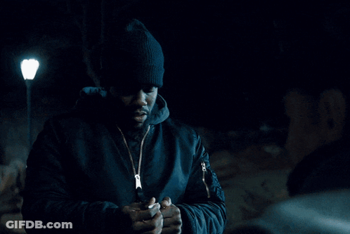 Man In Hat And Scarf Looking At Camera GIF