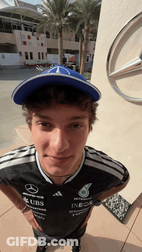Man In Hat And Shirt Saying UBS And INEOS GIF