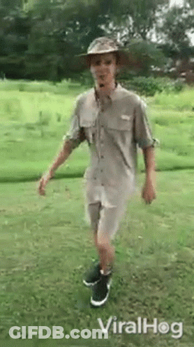 Man In Hat And Shorts Standing On One Leg GIF