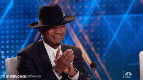 Man In Hat And Suit Clapping At Microphone World Of Dance GIF