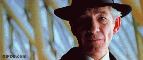 Man In Hat And Suit Looking Sideways GIF