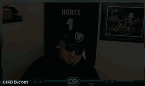 Man In Hat And Sunglasses Beside Football Wall GIF
