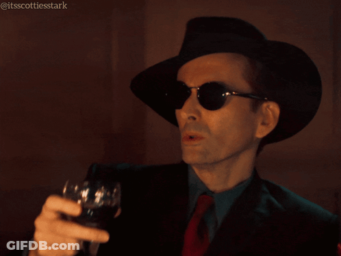 Man In Hat And Sunglasses Holding Wine Glass Saying Shades Of Dark Gray GIF