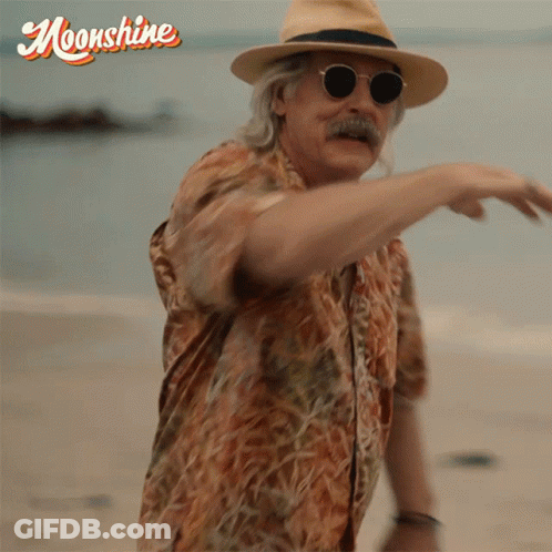 Man In Hat And Sunglasses On Beach With Moonshine GIF