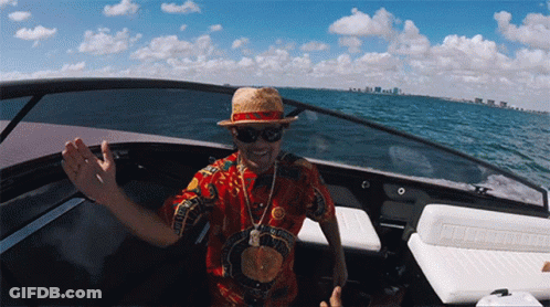 Man In Hat And Sunglasses On Boat With Gucci Shirt GIF