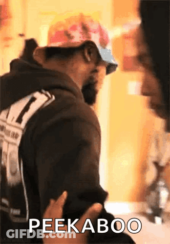 Man In Hat And Sunglasses Says Peekaboo GIF