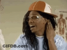 Man In Hat And Sunglasses Smiling Touching Hair GIF