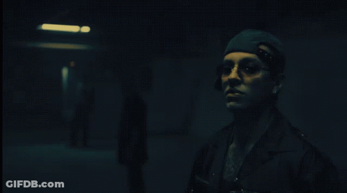 Man In Hat And Sunglasses Smoking Cigarette In Dark Room GIF