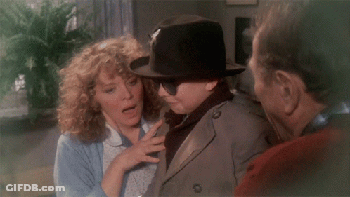 Man In Hat And Sunglasses Talks To Woman And Trench Coat Man GIF