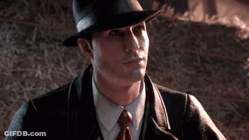 Man In Hat And Tie By Hay Bale GIF