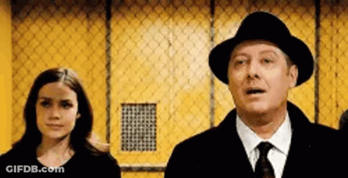Man In Hat And Tie Next To Woman In Black Shirt GIF