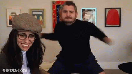 Man In Hat And Turtleneck Next To Stop Sign GIF