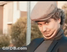 Man In Hat And Turtleneck Next To Stop Sign GIF