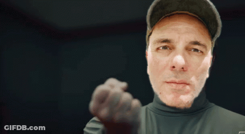 Man In Hat And Turtleneck Pointing GIF