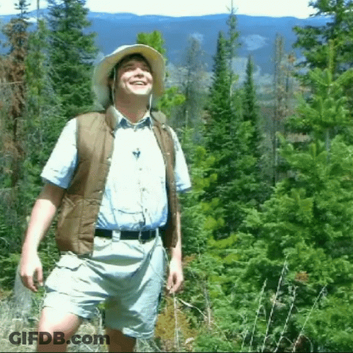 Man In Hat And Vest In Forest GIF