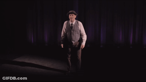 Man In Hat And Vest Purple Curtain Alone GIF