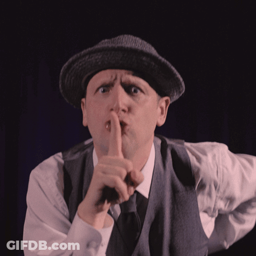 Man In Hat And Vest Shushing GIF