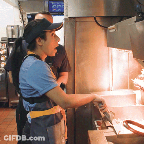 Man In Hat And Visor In Front Of McDonald's Display At 5:00 GIF