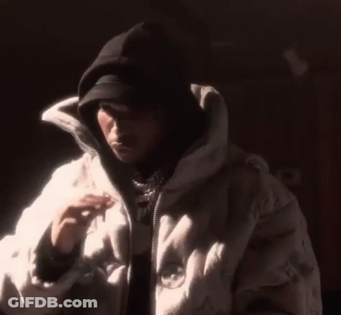 Man In Hat And White Jacket In Dark GIF