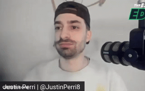 Man In Hat And White Shirt At Microphone GIF