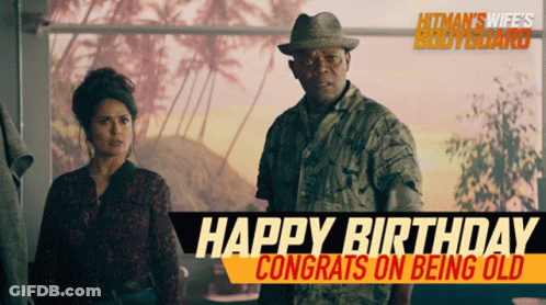 Man In Hat And Woman In Trench Coat Posing GIF