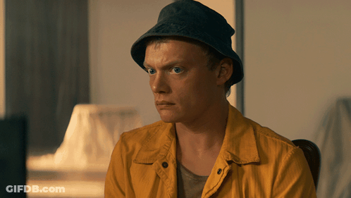 Man In Hat And Yellow Jacket Sitting In Chair GIF
